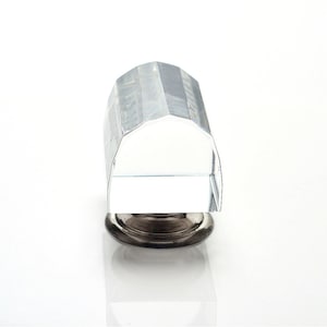 May include: A clear crystal cabinet knob with a faceted design and a silver base.
