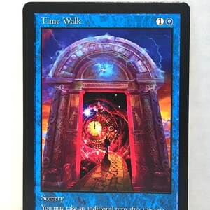 May include: A blue card with the text "Time Walk" at the top. The card features a fantasy illustration of a portal with a clock and a figure walking towards it. The card is labeled "Sorcery" with additional text below.