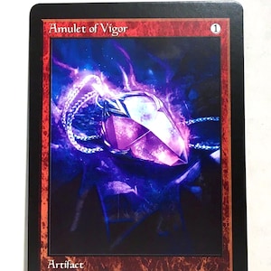 May include: A rectangular card featuring the text "Amulet of Vigor" and a purple gemstone pendant with a silver chain. The card has a red border and the word "Artifact" at the bottom. The text "If a permanent enters play tapped and under your control, untap it." is also present.
