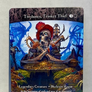 May include: Tinybones, Trinket Thief, a 1/2 Skeleton Rogue creature card from the Magic: The Gathering trading card game. The card features a skeletal pirate with a red hat and a lantern, surrounded by treasure and a blue background.