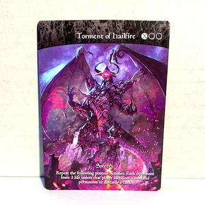May include: A fantasy card with a purple and black demon illustration and the title "Torment of hailfire". The card includes the text "Sorcery" and game instructions. The artwork shows a detailed illustration of a demonic creature with large wings.