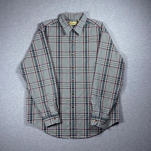 May include: A white ceramic mug with a black handle and the text "But First, Coffee" in a bold, black font. The mug is set against a neutral background, highlighting its simple design.