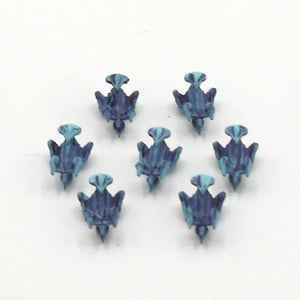 May include: Seven small, abstract sculptures in shades of blue and teal are arranged on a white background. Each sculpture has a unique, stylized shape with pointed bases and rounded tops, creating a visually interesting pattern.