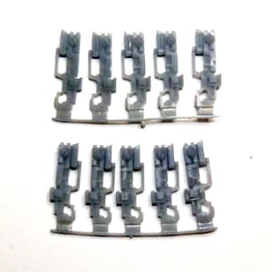 May include: Two sets of gray plastic model parts, each with five pieces. The pieces are rectangular with a complex shape, including a screw-like detail at the top and a hook-like feature at the bottom. The parts are arranged in rows.
