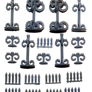 May include: A collection of gray miniature candelabras and candles. The candelabras have ornate, swirling designs and are of varying heights. Several sets of miniature candles are also included, perfect for a dollhouse or craft project.