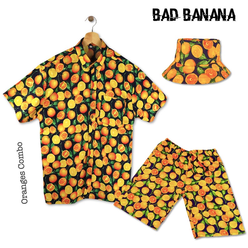 May include: A black, short-sleeved button-down shirt with a yellow and orange orange slice print. Matching yellow and orange shorts and a black bucket hat with the same print. The text "BAD BANANA" is printed in white on the hat. The text "Oranges Combo" is printed vertically on the left side of the image.