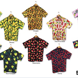 May include: Ten different short-sleeved shirts with various fruit patterns. The shirts are all on hangers and have a button-down collar. The shirts are all in different colours and have different fruit patterns, including watermelon, pineapple, banana, orange, and cherry. The text "BAD BANANA" is at the bottom of the image.