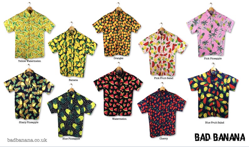 May include: Ten different short-sleeved shirts with various fruit patterns. The shirts are all on hangers and have a button-down collar. The shirts are all in different colours and have different fruit patterns, including watermelon, pineapple, banana, orange, and cherry. The text "BAD BANANA" is at the bottom of the image.