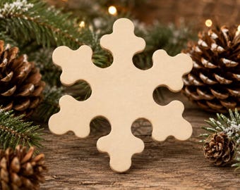 May include: A flat, light-colored wooden snowflake cutout with six symmetrical arms, each featuring rounded, clover-like tips. The surface is smooth and matte, showcasing the natural grain of the wood in a simple, geometric star shape.