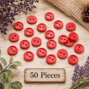 May include: A collection of small, round, bright red buttons, each featuring two central holes. A rectangular wooden sign with a distressed finish is positioned at the bottom, clearly displaying the black printed text 50 Pieces.