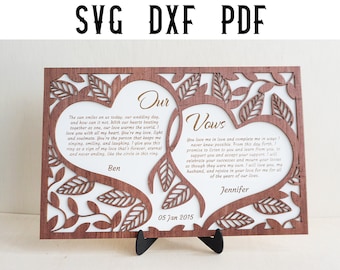 May include: A wooden heart-shaped wedding vow sign with a brown wood frame and white background. The text reads "Our" and "Vows" with the names Ben and Jennifer and the date 05 Jan 2015.