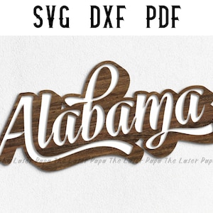 May include: A wooden sign with the word "Alabama" cut out in a cursive font. The sign is brown with a wood grain texture.