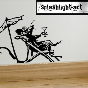 Puede incluir: Silueta negra de una rata relajándose en una silla de playa bajo una sombrilla, sosteniendo un cóctel. La imagen incluye el texto "splashlight-art" en un cuadro rectangular en la parte superior. La obra de arte es una calcomanía de pared.