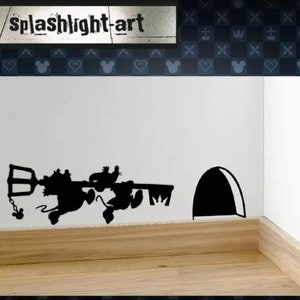May include: Black silhouette wall decal featuring cartoon characters hanging from a key. The decal includes a mouse-shaped chain and a stylized mouse hole. The text "splashlight-art" is at the top.