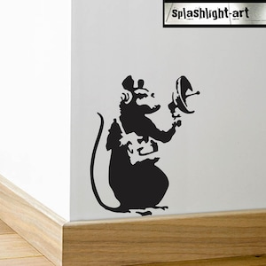 May include: Black silhouette of a rat holding a satellite dish, wearing headphones and a backpack. The rat is standing on its hind legs. The image is a stencil-style design. The text "splashlight-art" is in the upper right corner.