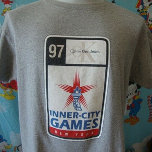 Vintage 90&#39;s Calvin Klein 1997 Inner City Games Arnold Schwarzenegger T Shirt M
