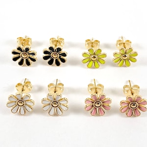 May include: Set of six pairs of gold-tone stud earrings featuring a daisy design. The daisies are in black, white, yellow, and pink.