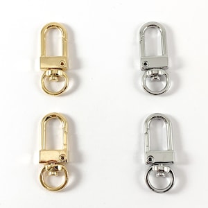 May include: Four metal keychains, two gold and two silver, with a swivel clasp and a trigger snap.