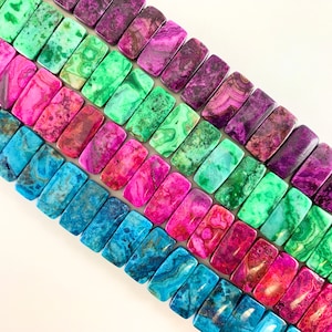 May include: A strand of colorful agate gemstone beads. The beads are rectangular and have a variety of patterns and colors, including blue, green, pink, and purple.
