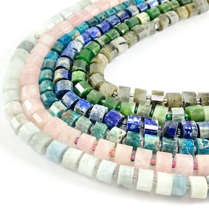 May include: A close-up of a variety of gemstone beads, including aquamarine, rose quartz, green jade, lapis lazuli, and labradorite. The beads are all faceted and have a polished finish.