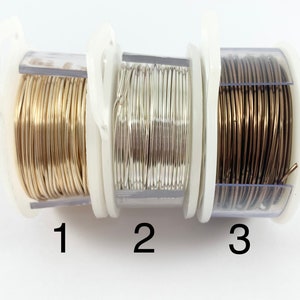 May include: Three spools of wire in clear plastic containers. The spools are labeled 1, 2, and 3. The wire is gold, silver, and bronze.