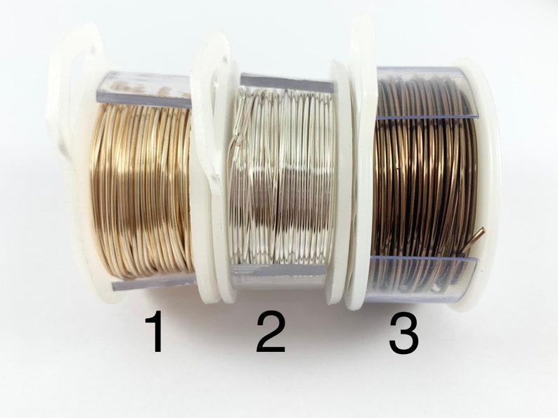 May include: Three spools of wire in clear plastic containers. The spools are labeled 1, 2, and 3. The wire is gold, silver, and bronze.