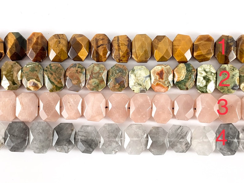 May include: Four rows of faceted gemstone beads. The top row is tiger's eye, the second row is green and brown jasper, the third row is pink, and the bottom row is gray.