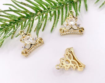 May include: Three gold-tone crown-shaped charms with clear rhinestone accents. The charms are perfect for jewelry making or adding a touch of sparkle to crafts.