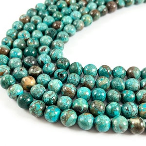 May include: A strand of round, turquoise blue and brown gemstone beads. The beads have a mottled, marbled appearance.