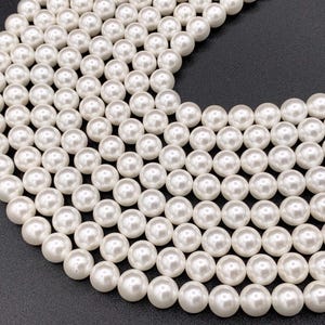 May include: A strand of white pearl beads, perfect for jewelry making or crafting projects.