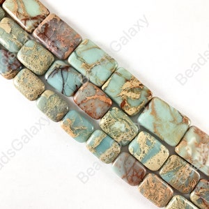 May include: A strand of light blue, brown, and gold rectangular gemstone beads. The beads have a marbled pattern and are strung on a clear thread.