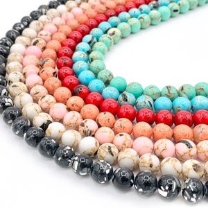 May include: A variety of round, colorful beads with marbled patterns. The beads are arranged in a circle, with the darkest beads on the bottom and the lightest beads on the top. The beads are made of natural stone and are perfect for jewelry making.