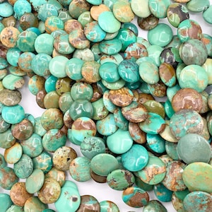 May include: A strand of turquoise gemstone beads, each bead is a round, flat disc with a mottled green and brown pattern.