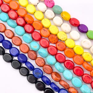 May include: A strand of oval-shaped gemstone beads in various colors, including black, blue, turquoise, red, orange, yellow, and white. The beads are strung on a clear thread and are arranged in a staggered pattern.