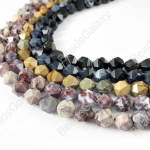 May include: A strand of multi-colored gemstone beads. The beads are faceted and have a starburst shape. The colors of the beads are brown, red, tan, and blue.
