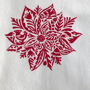 May include: Red Christmas-themed design featuring a stylized poinsettia with birds, bells, and other festive elements.