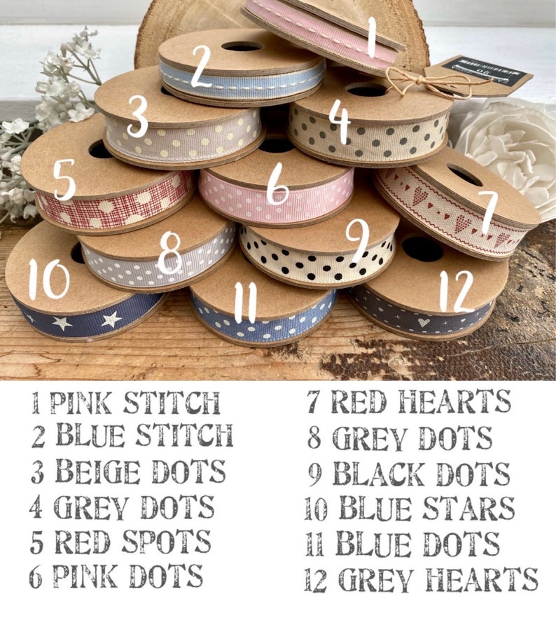 May include: Twelve spools of ribbon with different patterns and colours. The ribbons are numbered 1 through 12 and each ribbon has a corresponding description below the image. The ribbons include pink stitch, blue stitch, beige dots, grey dots, red spots, pink dots, red hearts, grey dots, black dots, blue stars, blue dots, and grey hearts.