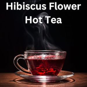 May include: A glass teacup and saucer filled with red hibiscus flower tea. Steam rises from the cup against a dark backdrop. The text "Hibiscus Flower Hot Tea" is displayed above the cup.