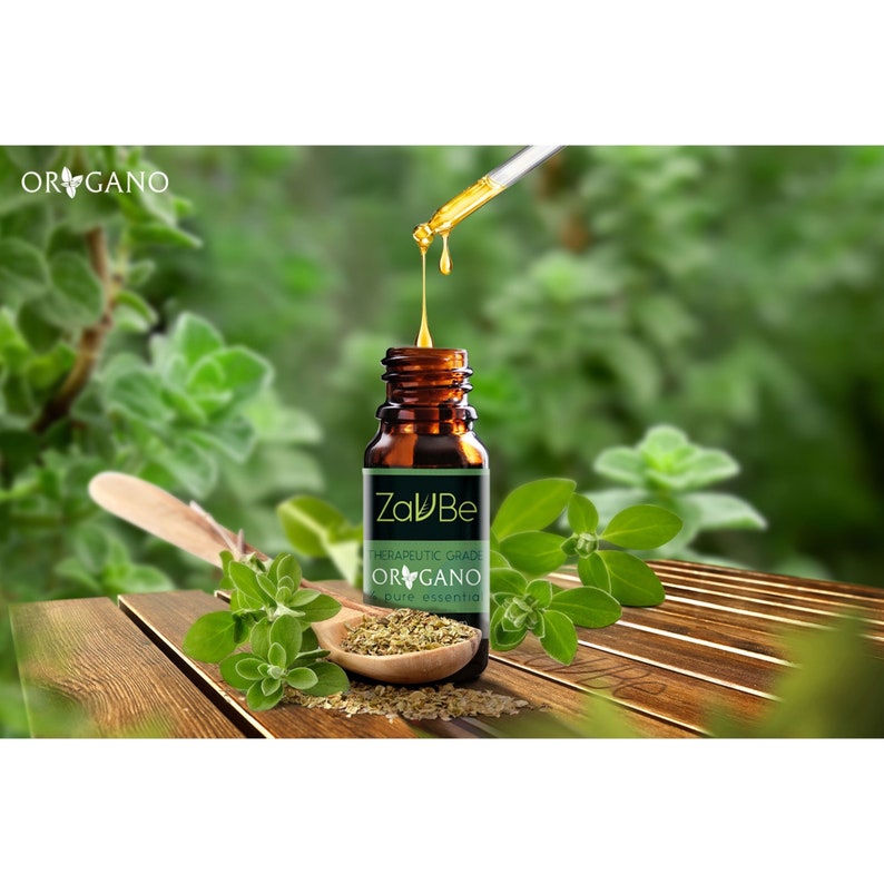 May include: A brown glass bottle with a dropper filled with oregano essential oil. The bottle has a white label with the text "ZaluBe" and "Therapeutic Grade Oregano pure essential oil".