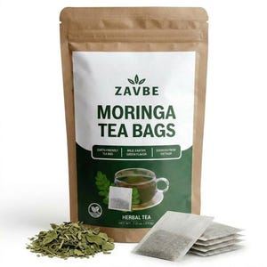 May include: A brown paper bag of Moringa tea bags with the brand name "ZAVBE" printed on the front. The label also includes the text "MORINGA TEA BAGS", "EARTH-FRIENDLY TEA BAG", "MILD, EARTHY GREEN FLAVOR", and "SOURCED FROM VIETNAM". A pile of loose tea leaves and tea bags are visible.