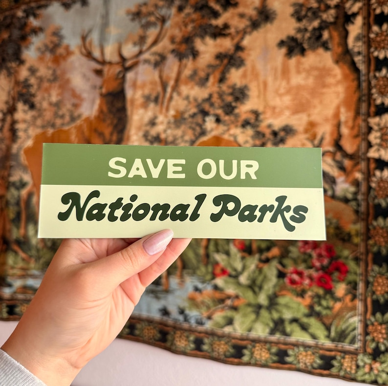 Green and beige bumper sticker that reads, Save Our National Parks
