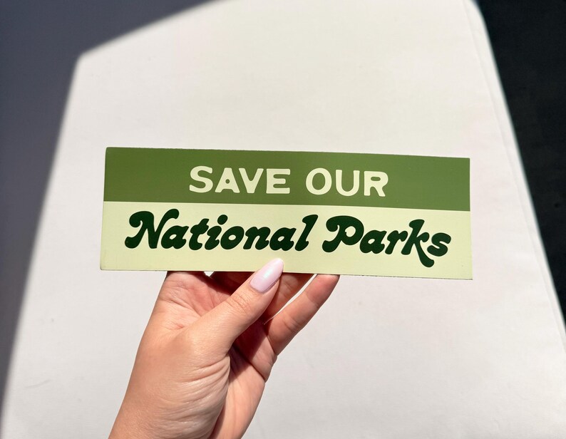 Green and beige bumper sticker that reads, Save Our National Parks