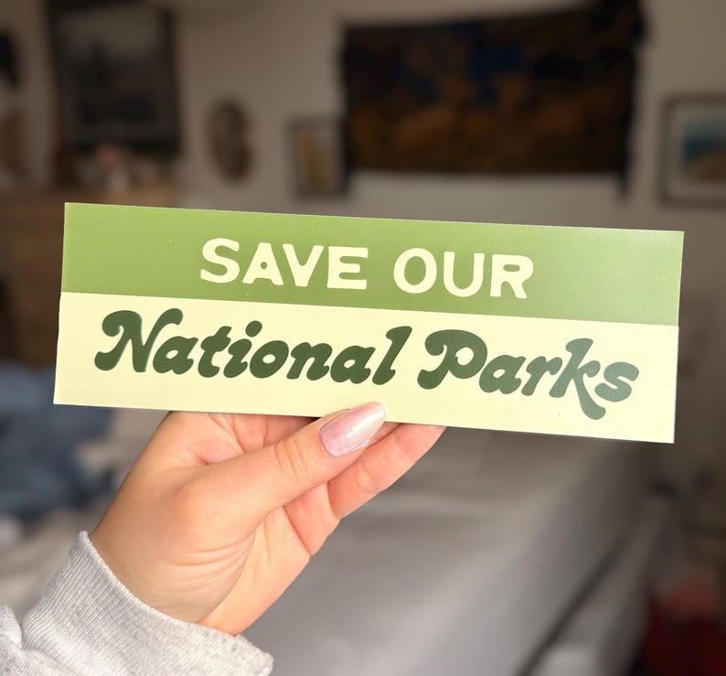 Green and beige bumper sticker that reads, Save Our National Parks