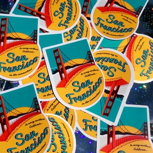 Sticker with a teal sky and yellow sun with the red Golden Gate Bridge. In teal script lettering it reads, San Francisco, and around it reads, In sunny northern California... in the summertime! Multiple stickers scattered about.