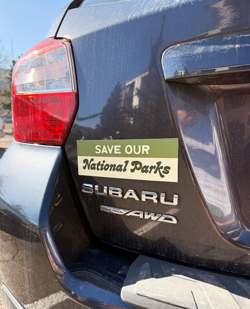 Green and beige bumper sticker that reads, Save Our National Parks