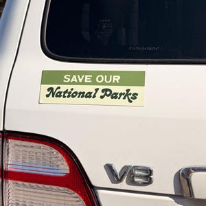Green and beige bumper sticker that reads, Save Our National Parks
