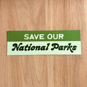 Green and beige bumper sticker that reads, Save Our National Parks