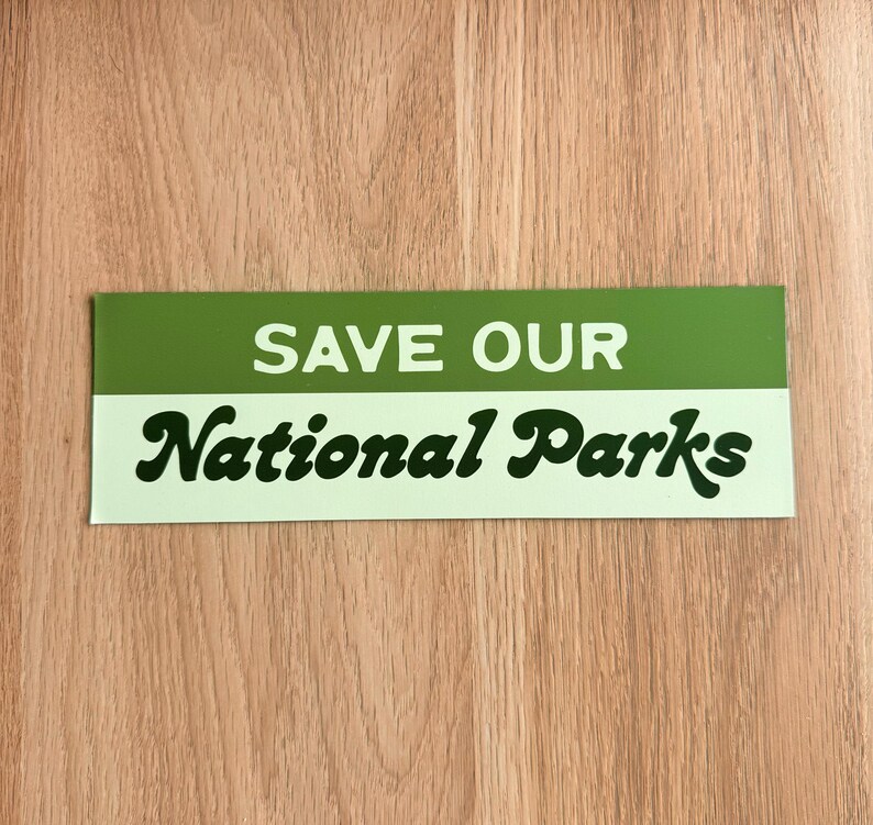 Green and beige bumper sticker that reads, Save Our National Parks