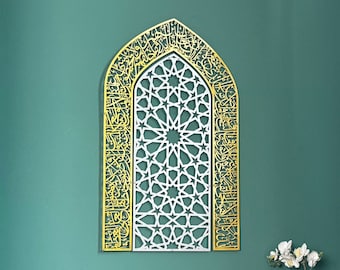 May include: A wooden prayer stand with intricate carvings, a gold and white Islamic calligraphy wall art, and a small potted plant on a wooden table with drawers.