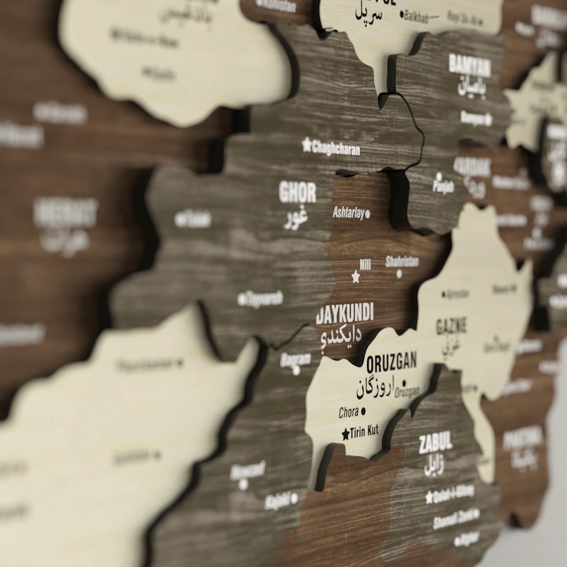 May include: A wooden map of Afghanistan with the names of the provinces and major cities labeled in both English and Dari. The map is made of individual pieces of wood that are joined together to form the shape of the country.